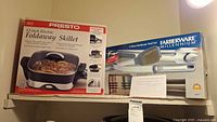 Both boxed items shown on a shelf: Presto electric skillet box with food image, Farberware BBQ tool set box.