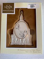 Full view of boxed Lenox Pope Francis commemorative ornament in display packaging showing front design and price sticker.