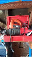 Craftsman Saws-All CMES300 and Black & Decker Jigsaw JS515 power tools in one red case showing condition and accessories.