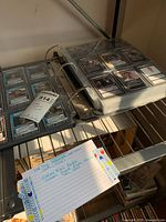 Image showing the binder open with plastic sleeves filled with Star Trek trading cards visible, a note card listing info about the collection nearby.