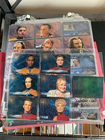 Photo of front side of Star Trek Voyager character trading cards featuring multiple crew members in protective sheet