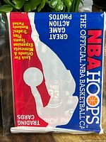 Sealed 1989 NBA Hoops NBA basketball trading card pack with a design showing Patrick Ewing in an All Star jersey number 33 behind the logo and text.