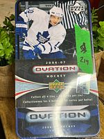 Front of sealed 2006-07 Upper Deck Ovation hockey collectible tin showing player in Toronto Maple Leafs uniform and product branding.
