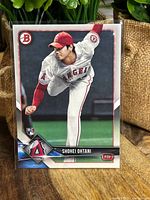 Front of 2018 Shohei Ohtani Bowman Rookie Card showing Ohtani pitching in Angels uniform with Bowman and RC logos.
