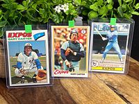 Three Gary Carter baseball cards from Topps in protective sleeves, showing 1977, 1978, and 1979 Montreal Expos uniforms and poses.