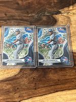 Two Arjun Nimmala baseball cards in protective sleeves, showing front artwork and logos.