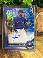 Front of the baseball card showing Luis Meza in Blue Jays uniform, holographic background, autograph, and serial number 034/150.