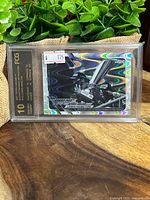 Front of the graded 2021 Topps Chrome F1 Lewis Hamilton B&W Ray Wave Refractor card showing holographic wave pattern and the image of Hamilton holding a trophy.