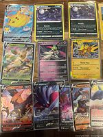 Selection of VMAX and V cards including Flying Pikachu VMAX, Umbreon V, Leafeon V, Iron Valiant, Zapdos V, Talonflame V, Malamar V, Crobat V, Rhyperior V and Stoutland V