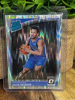 Front of the Jalen Brunson Panini Optic Shock Rated Rookie card showing player image in Dallas Mavericks uniform with holographic shock design