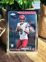Front of the Jayden Daniels rookie card showing player photo, name, team and Topps Chrome branding.