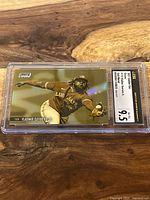 Front of the gold minted baseball card showing Vladimir Guerrero Jr. fielding, encapsulated and graded 9.5 by CSG.