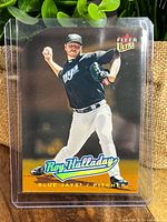 Front view of Roy Halladay Fleer Ultra Gold Medallion Die Cut baseball card in protective sleeve showing Halladay pitching in Blue Jays uniform.