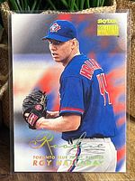 Front of Roy Halladay baseball card showing player in Blue Jays uniform in pitching pose, with Skybox Premium logo and gold foil signature.