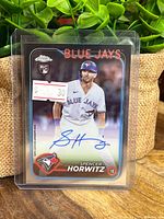 Front of Spencer Horwitz Topps Chrome 2024 Rookie Autograph card with autograph and Blue Jays branding displayed inside a protective plastic sleeve.