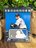 Front of the Roy Halladay baseball card showing the player pitching, blue background, and Toronto Blue Jays text.