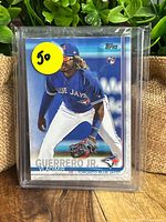 Front of Vladimir Guerrero Jr. rookie card sealed in plastic sleeve with Topps logo and rookie card badge.