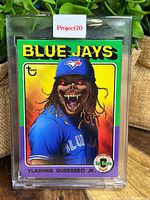 Front of the Vladimir Guerrero Jr Topps Project70 baseball card depicting horror art by Alex Pardee, encased in clear plastic holder.