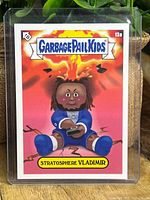Front of 'Stratosphere Vladimir' Garbage Pail Kids trading card, showing cartoon character resembling Vladimir Guerrero Jr. in Blue Jays baseball attire with explosion background.