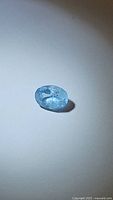 Oval cut natural aquamarine gemstone shown from multiple angles illustrating clarity, cut, and color.