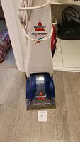 Front view of Bissell QuickSteamer Plus carpet cleaner showing branding and general condition.