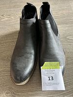 Top-down view of the pair of black Bruno Marc Chelsea boots showing the toe areas and front sides, slight wear marks noted.