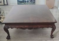 Full top-down view of the rectangular flame mahogany coffee table with carved apron and ball & claw feet.