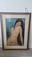 Full view of framed print depicting a reclining nude female
