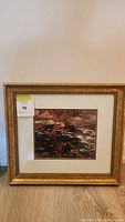 Full view of the framed painting showing gold frame and artwork 'The Red Maple' by AY Jackson