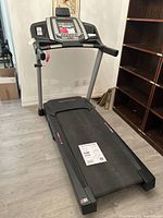 Full view of HealthRider H70T treadmill showing running deck, handrails and console.