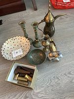 Overall shot of all metal decor items arranged on the floor showing all items in lot