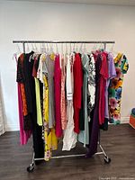 Photo of the full rack showing all dresses hanging on rail with variety of colors and patterns
