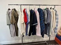 Wide shot of assorted men's shirts on a clothing rack, showing various colors and styles all size large.