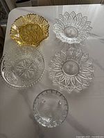 All five glass and crystal serving bowls displayed on white table.