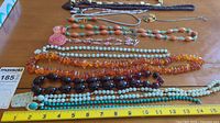 overview of all ten necklaces laid out on table