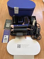 Overview of Dyson Airwrap kit including body, attachments, case and manual