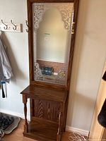 Full view of hall table showing whole piece with mirror, coat hooks, and base shelf.