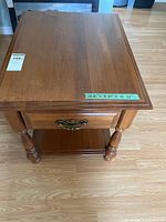 Top and front view of the solid wood side table showing surface and dimensions.