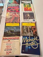 Photo of 9 vinyl record covers including More Dirty Dancing, Disco Motion 2-record set, Hair Broadway cast, Beethoven: The Pastoral Sixth Symphony, Liszt/Smetana/Dvořák by Karajan, The Blue Danube Waltzes & Polkas, The Best Original Soundtracks and Great Themes, and Midnight Hustle disco compilation.