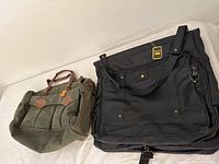 Two bags displayed side by side, the green Allasandro duffel bag and the black Bugatti garment bag