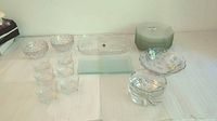 Entire glassware set with platter, bowls, plates, fruit bowl, and ashtray arranged on a table