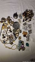 Photo displaying the entire assortment of jewelry making supplies, featuring loose beads, pendants, metal findings, chains, and earring parts.