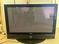 Front view of Samsung HP-R4272C plasma TV showing screen, frame, base stand and power cord.