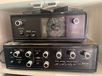 Front view of stacked Sansui tuner (top) and amplifier (bottom).
