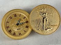 Image showing the clock face revealed when the faux gold coin design is rotated open. The clock features Roman numerals and the Bulova logo.