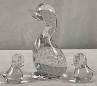 Front view of the mother duck and two smaller ducklings showing size relationship and overall shape with internal bubble decoration.