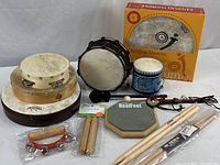 Full collection including Christine Stevens Healing Drum Kit in box, tambourines, hand drums, practice pad, claves, drumsticks and mallets.