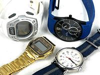 Four watches: Timex Ironman white neoprene, Skagen Denmark blue neoprene with black chronograph face, XSNE gold tone digital watch with metal bracelet, Timex Indiglo with blue canvas band and white face.