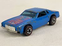 Front angled view of blue Hot Wheels car showing wear and hood graphics.