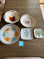All five ceramic bowls and plates displayed on table